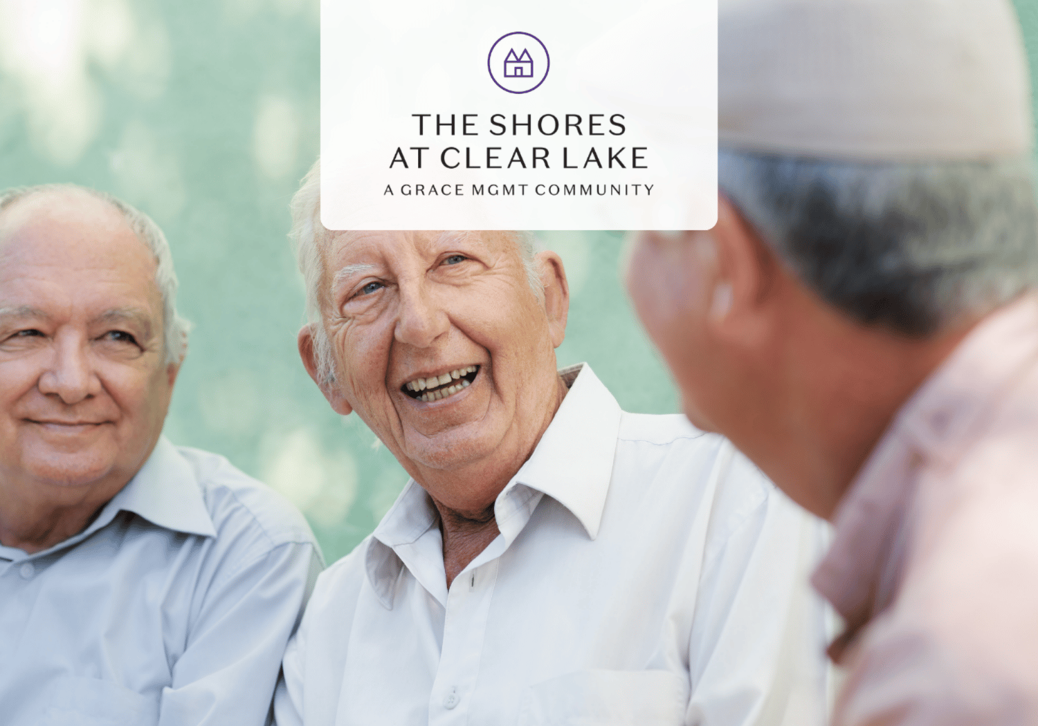 Three elderly men smiling and chatting outdoors, with a white badge showing The Shores at Clear Lake branding overlaid in the center.